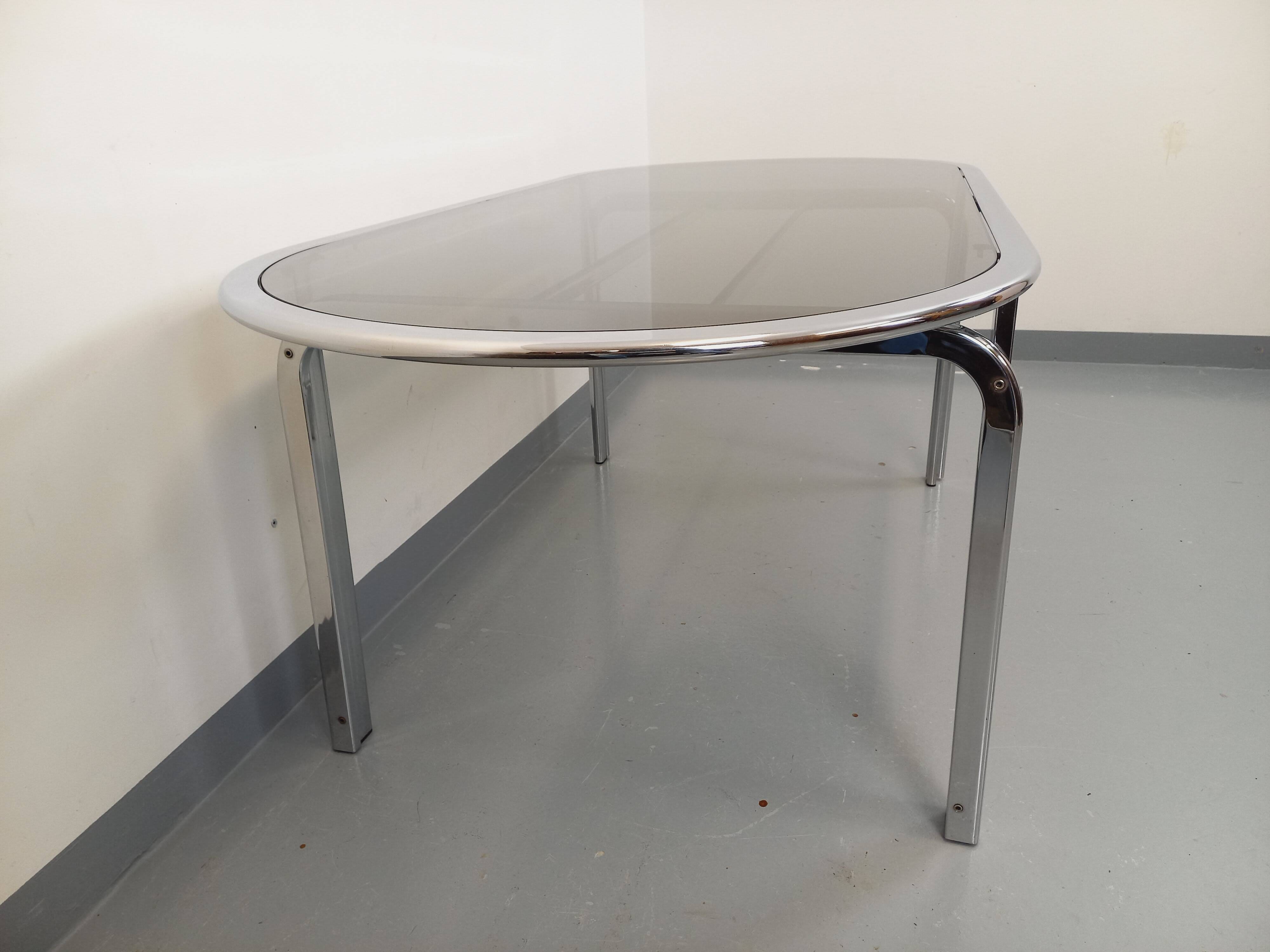 Vintage oval dining table in smoked glass and chrome metal, Space Age style.