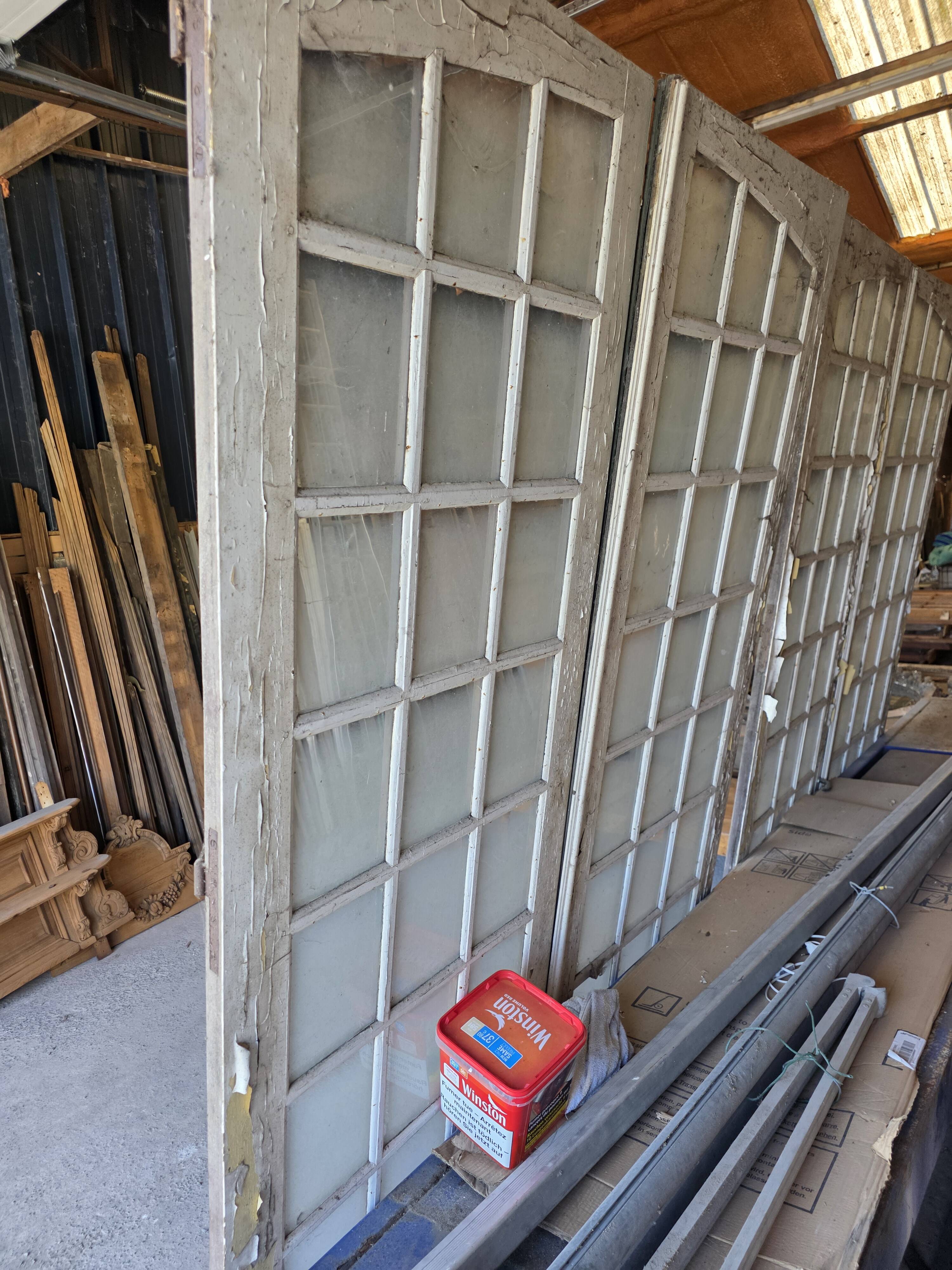 Two pairs of solid oak doors with small panes.