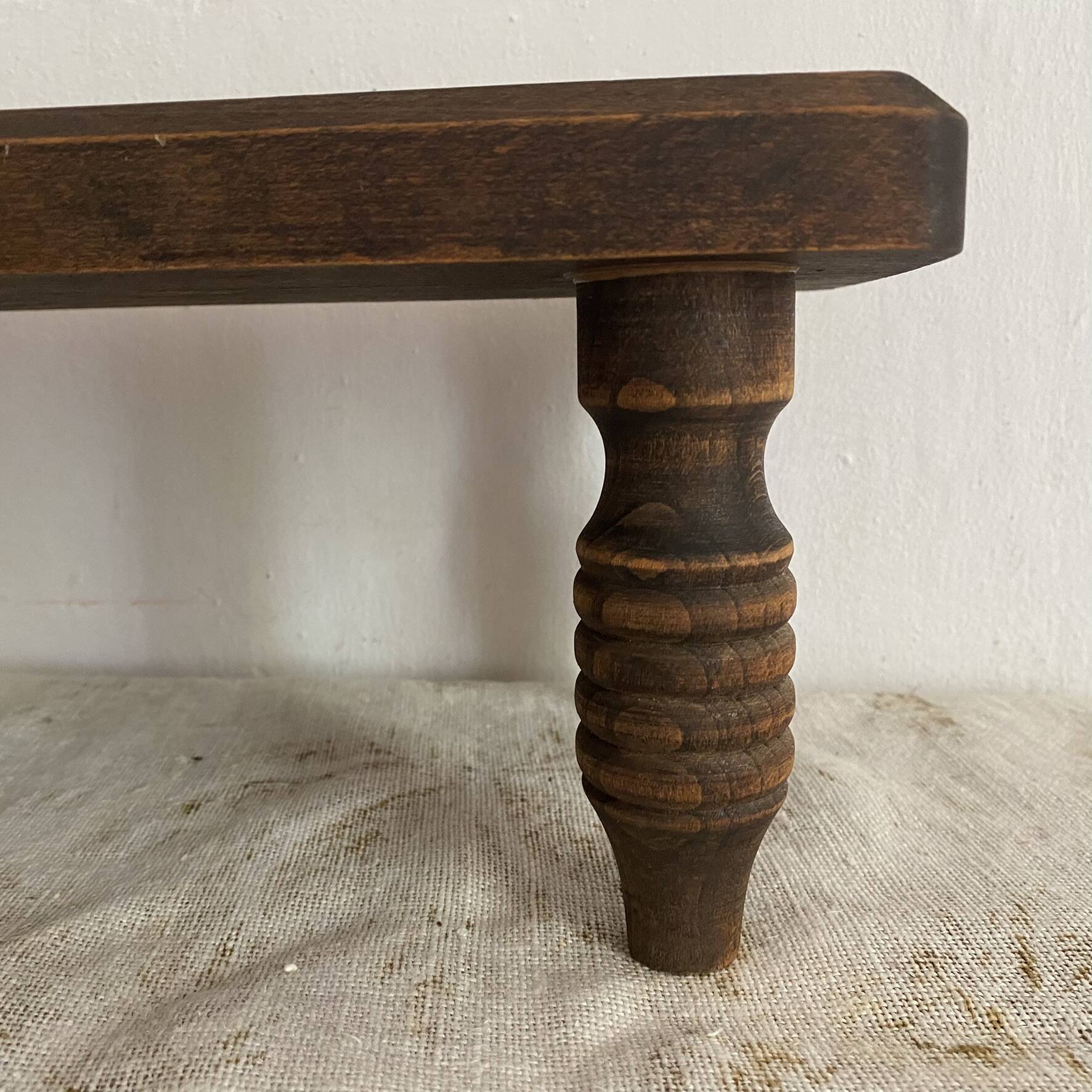 Low stool, turned wooden legs.