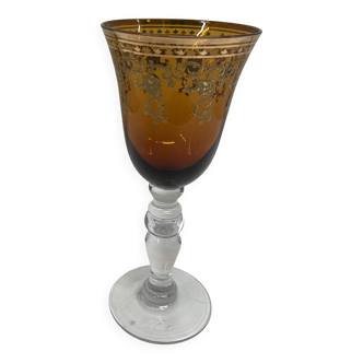 Vintage amber translucent footed glass with golden patterns.