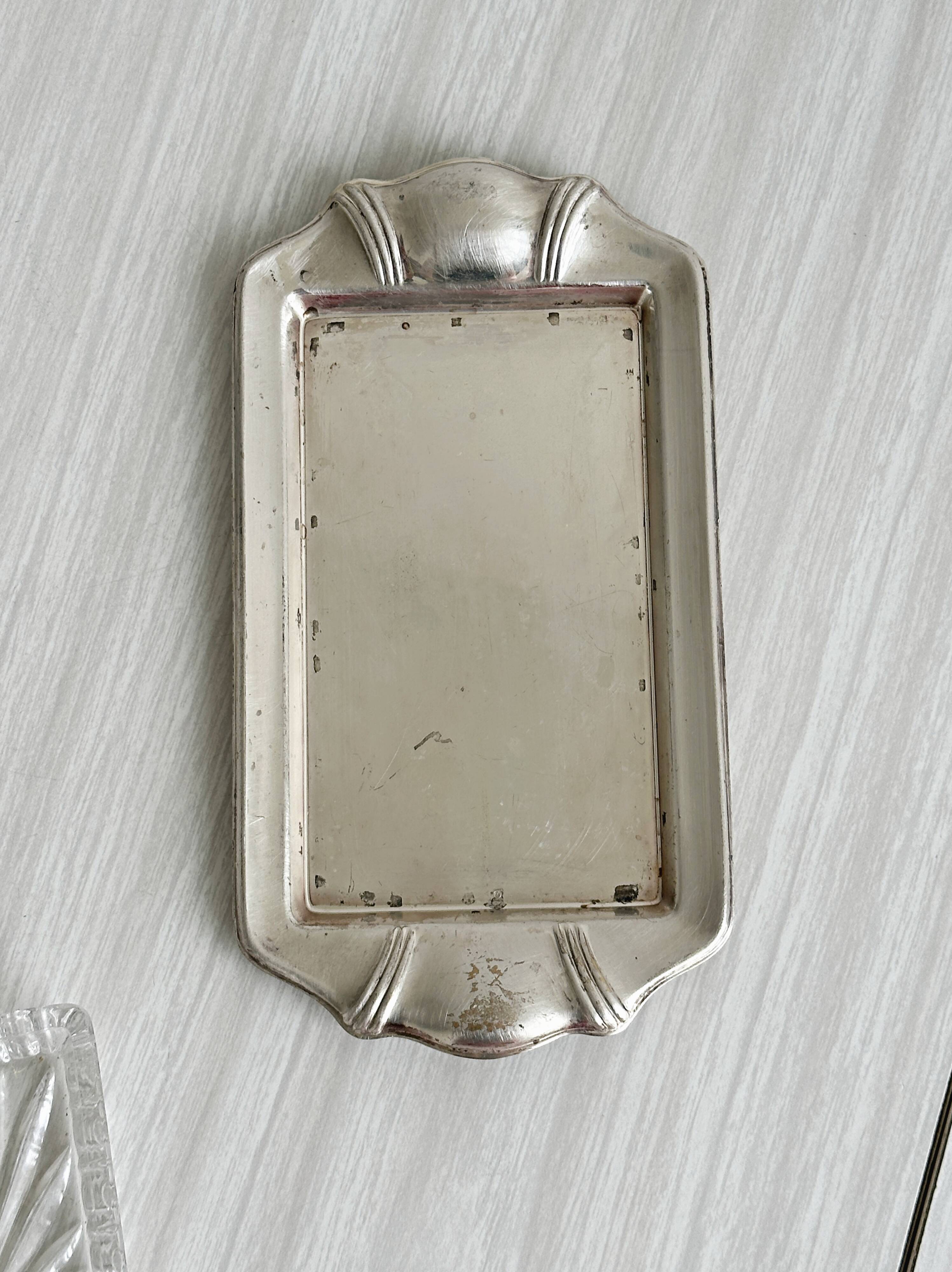Metal butter dish and thick rectangular glass bowl.
