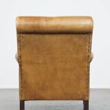 Stylish patinated vintage sheepskin armchair with a comfortable seat