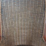 Armchair in woven rattan and exotic wood
