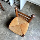 Brutalist low chair in dark wood and straw no. 1