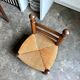 Low brutalist chair in dark wood and straw n°1