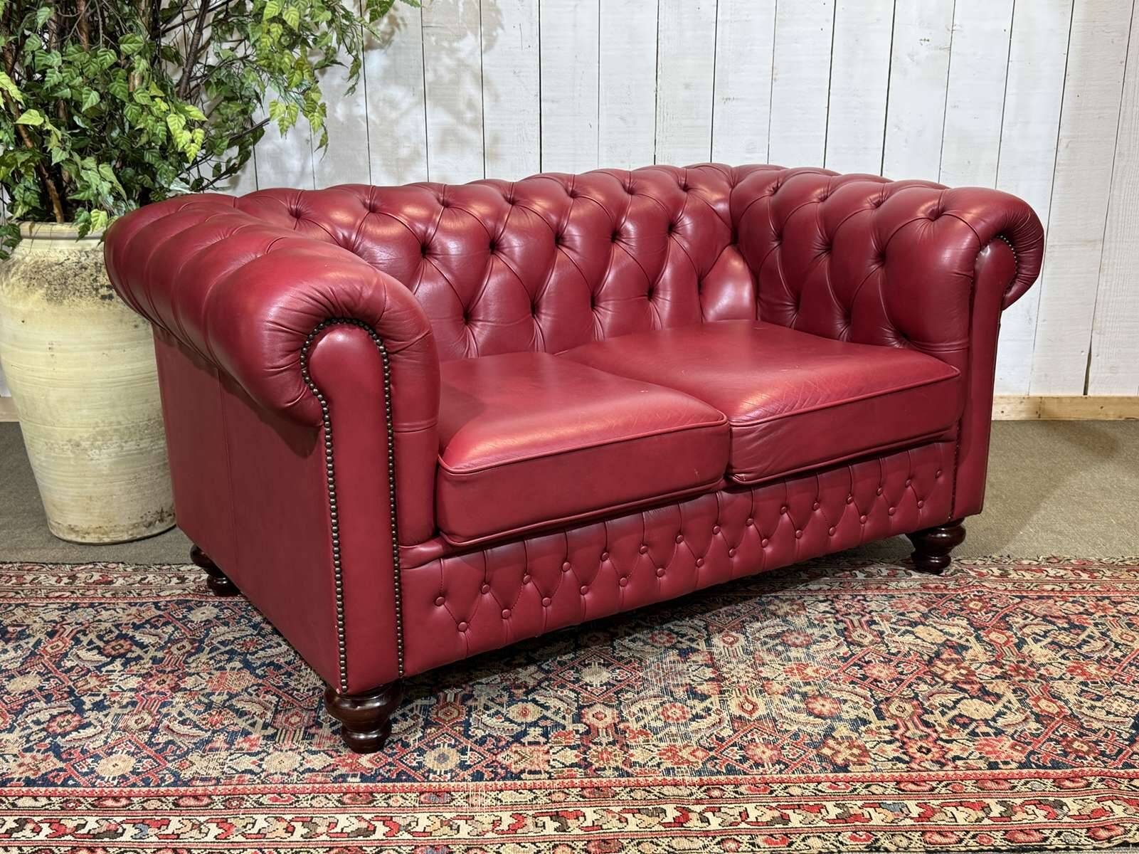 Chesterfield 2-seater leather sofa, modern production from the 2000s.