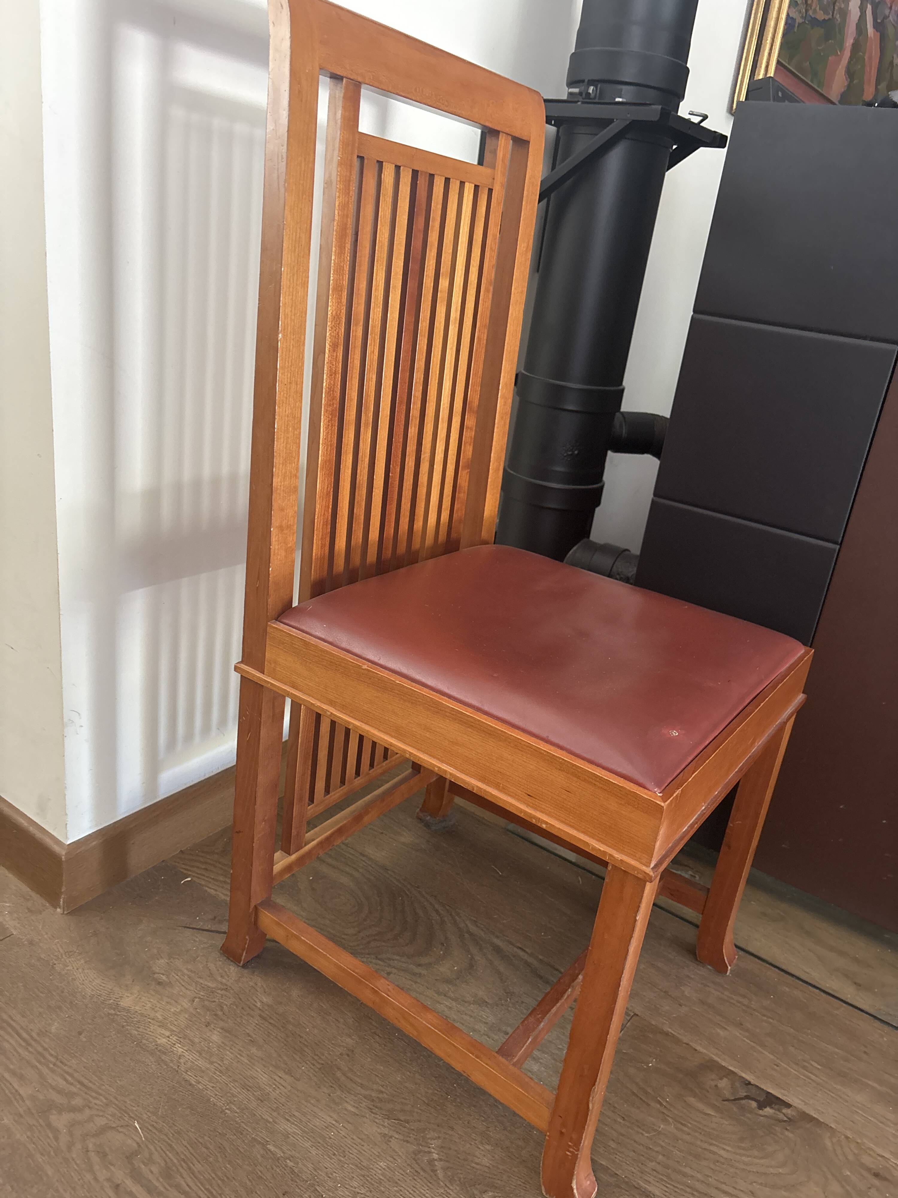 "Frank Lloyd Wright set with a table and its eight chairs."