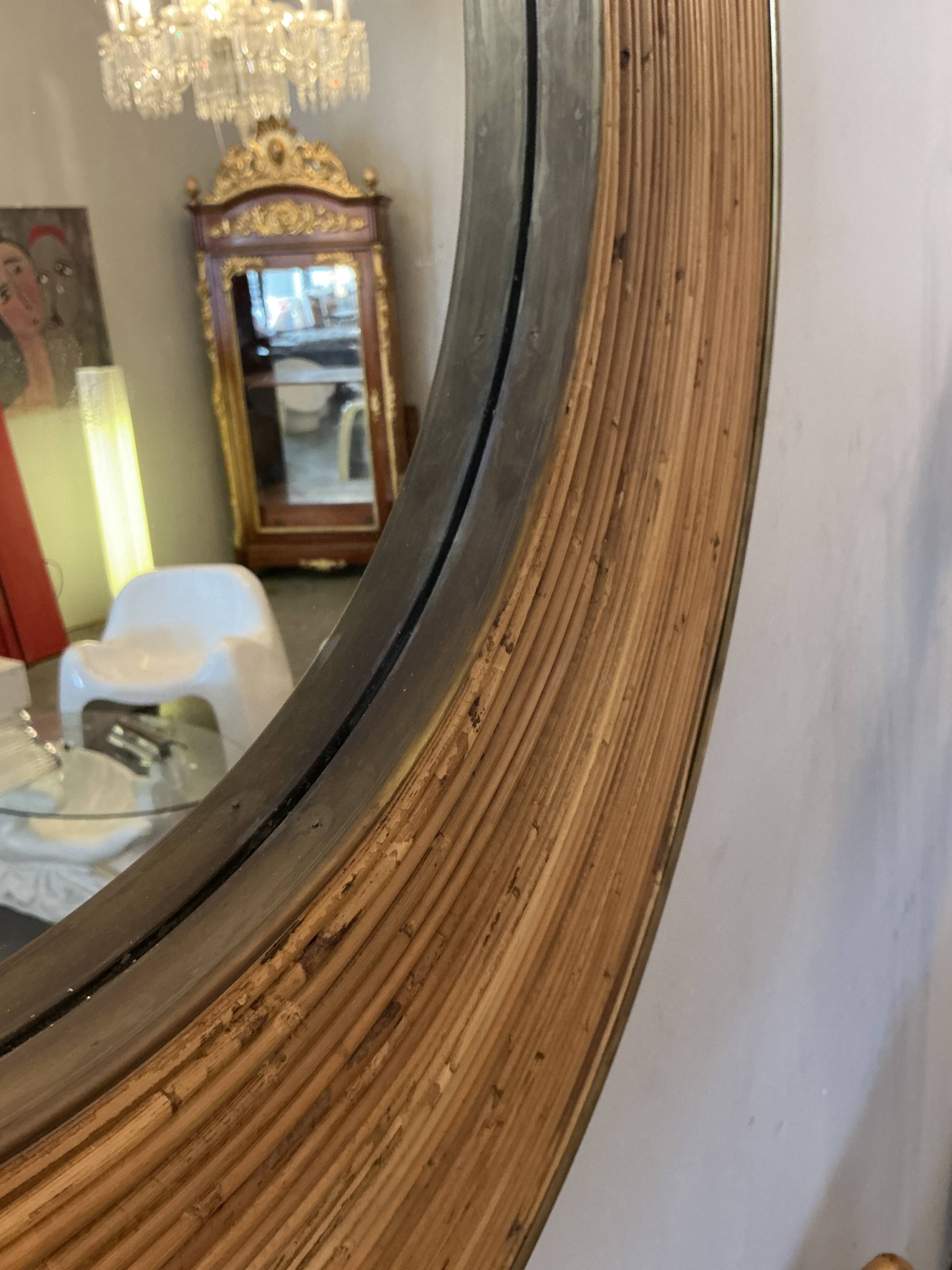 Large round mirror in rattan and brass