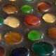Square section cut glass and metal decorated with multicolored glass cabochons