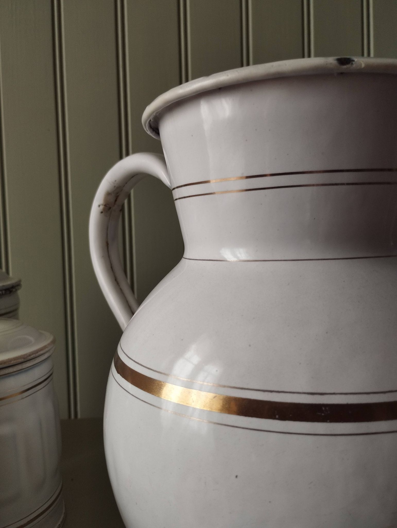Rare large, pot-bellied toilet jug in white enamelled sheet metal with gold edging
