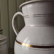 Rare large, pot-bellied toilet jug in white enamelled sheet metal with gold edging
