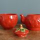 Teapot and cup in the shape of a strawberry.