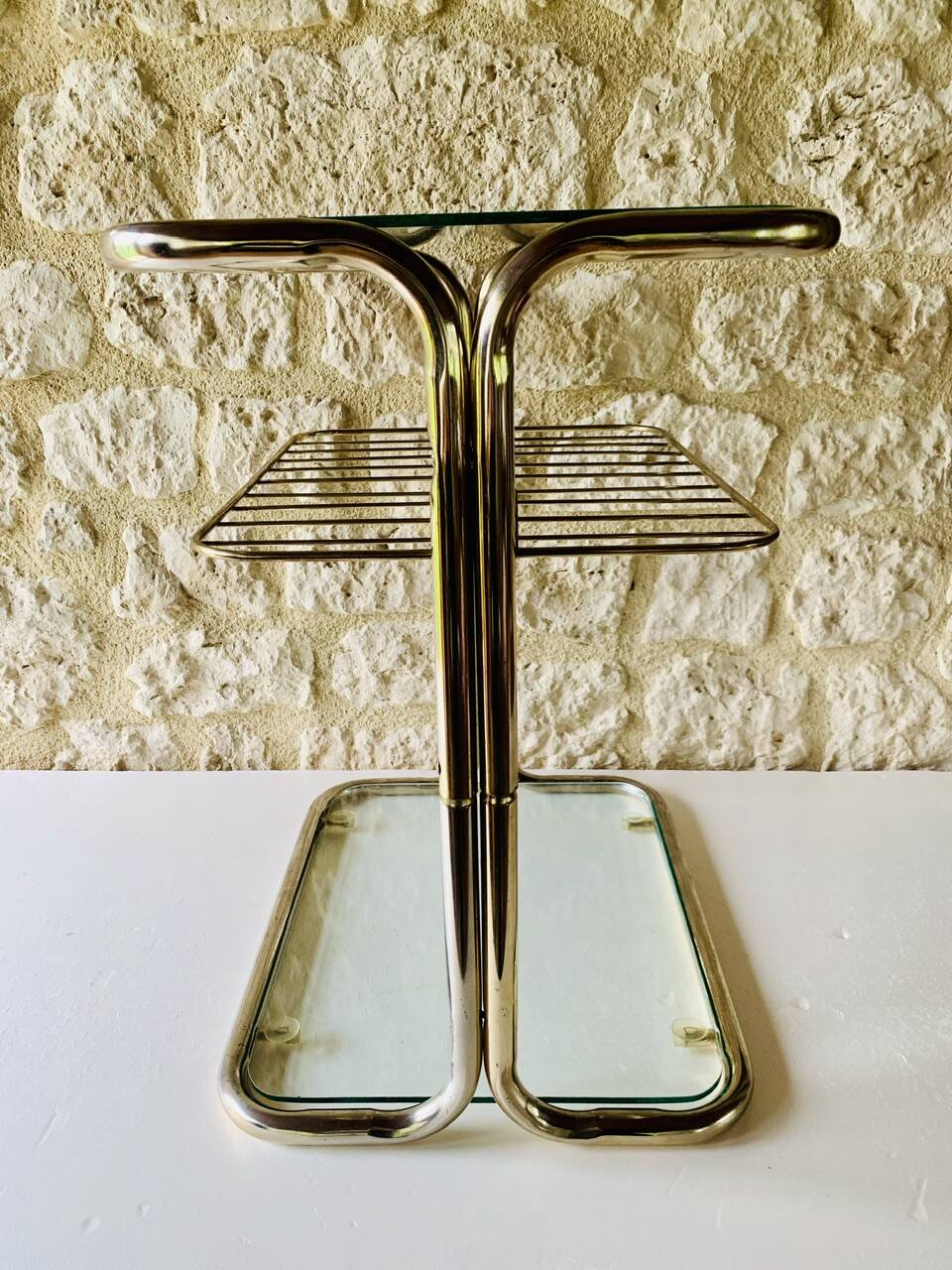 Glass and brass side table with magazine rack, circa 1970's