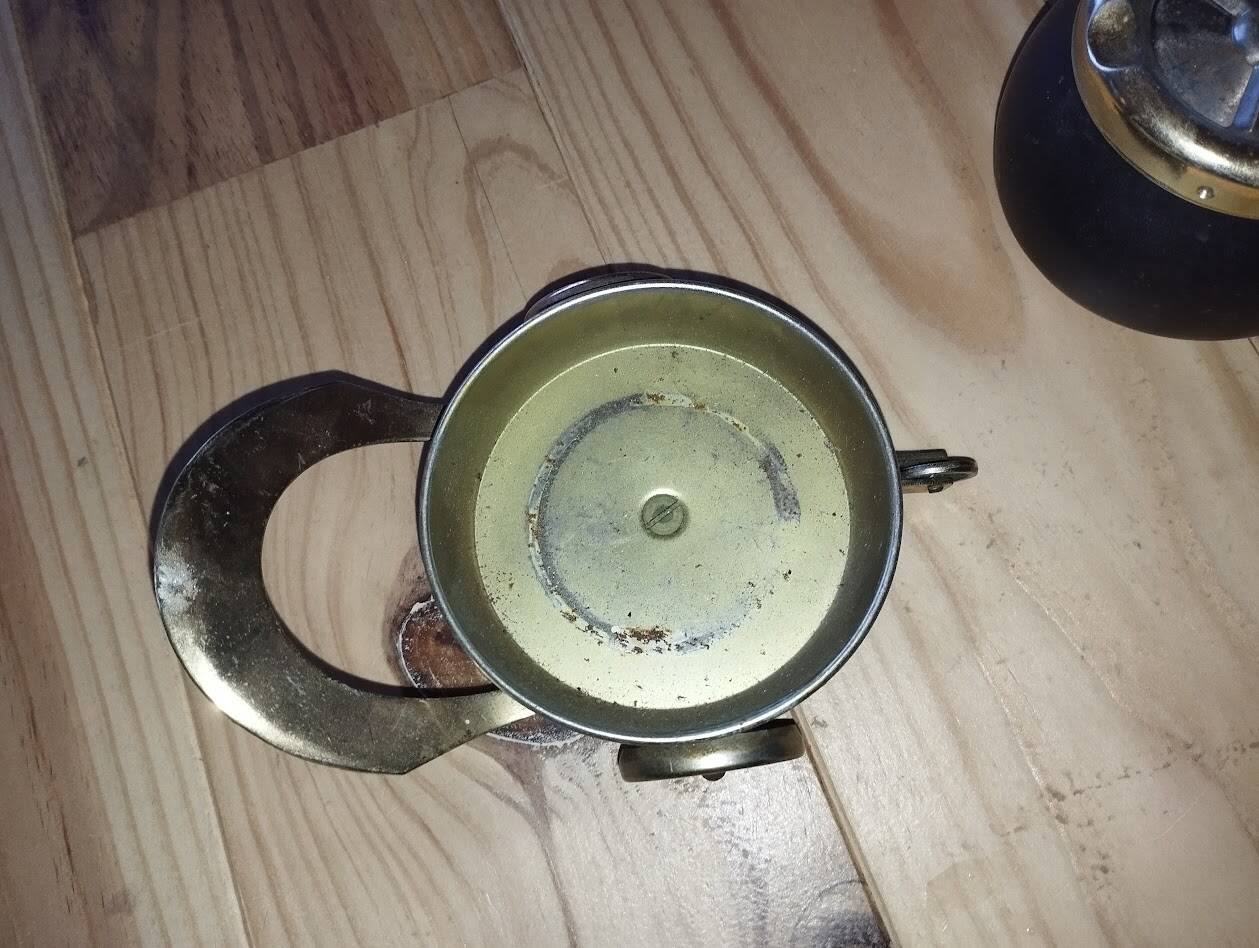 Original vintage ashtray on a small wheeled stand.