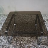 Table basse Roche Bobois 1970 verre fumé piètement en métal chromé.
