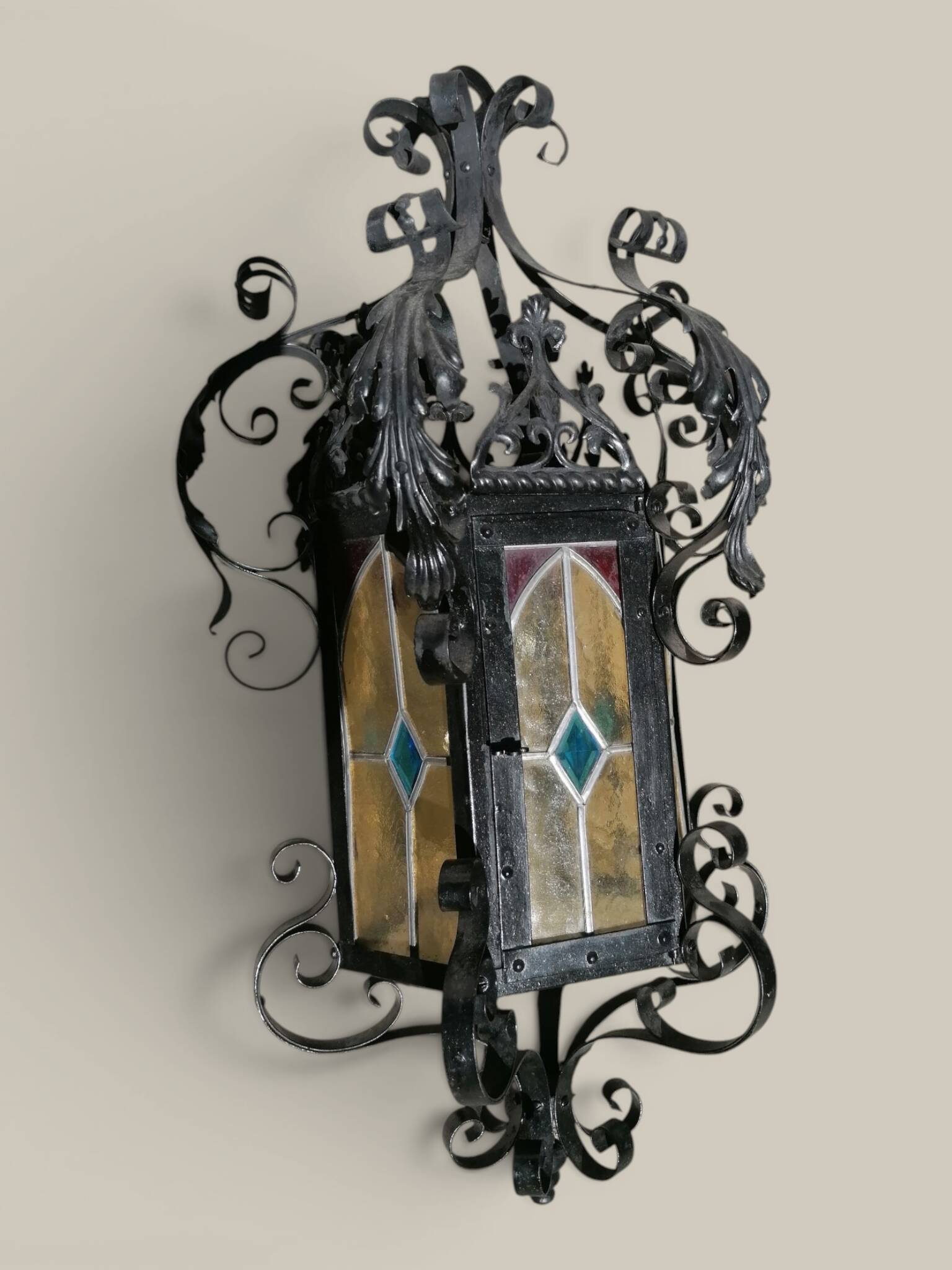 Black wrought iron lantern with stained glass. Medieval, Gothic decoration.