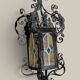 Black wrought iron lantern with stained glass. Medieval, Gothic decoration.