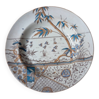 Plat creux décor tropical polychrome par G&W Melbourne, vers 1885