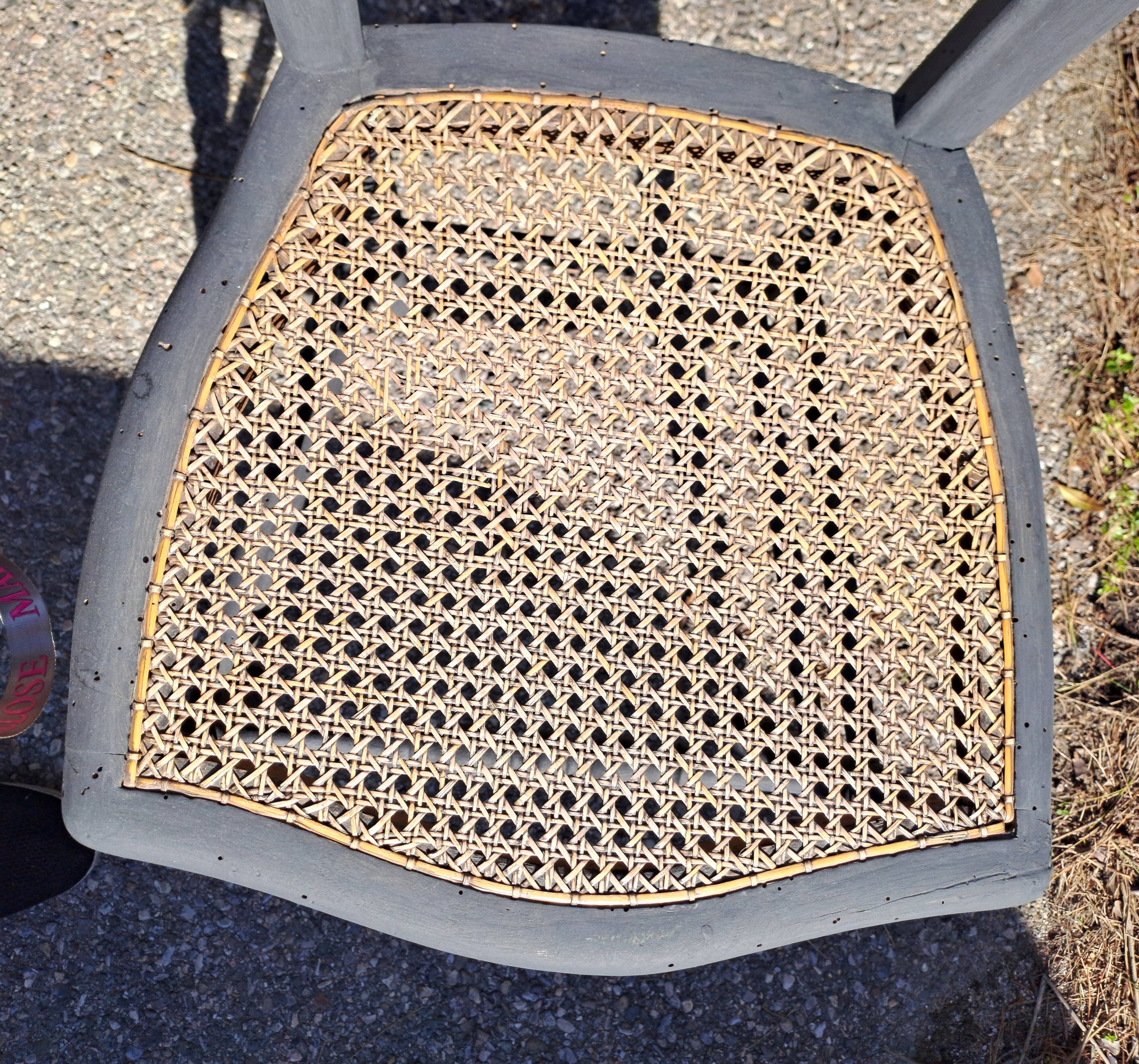 Pair of 2 chairs with cane seats in black wood, circa 1940