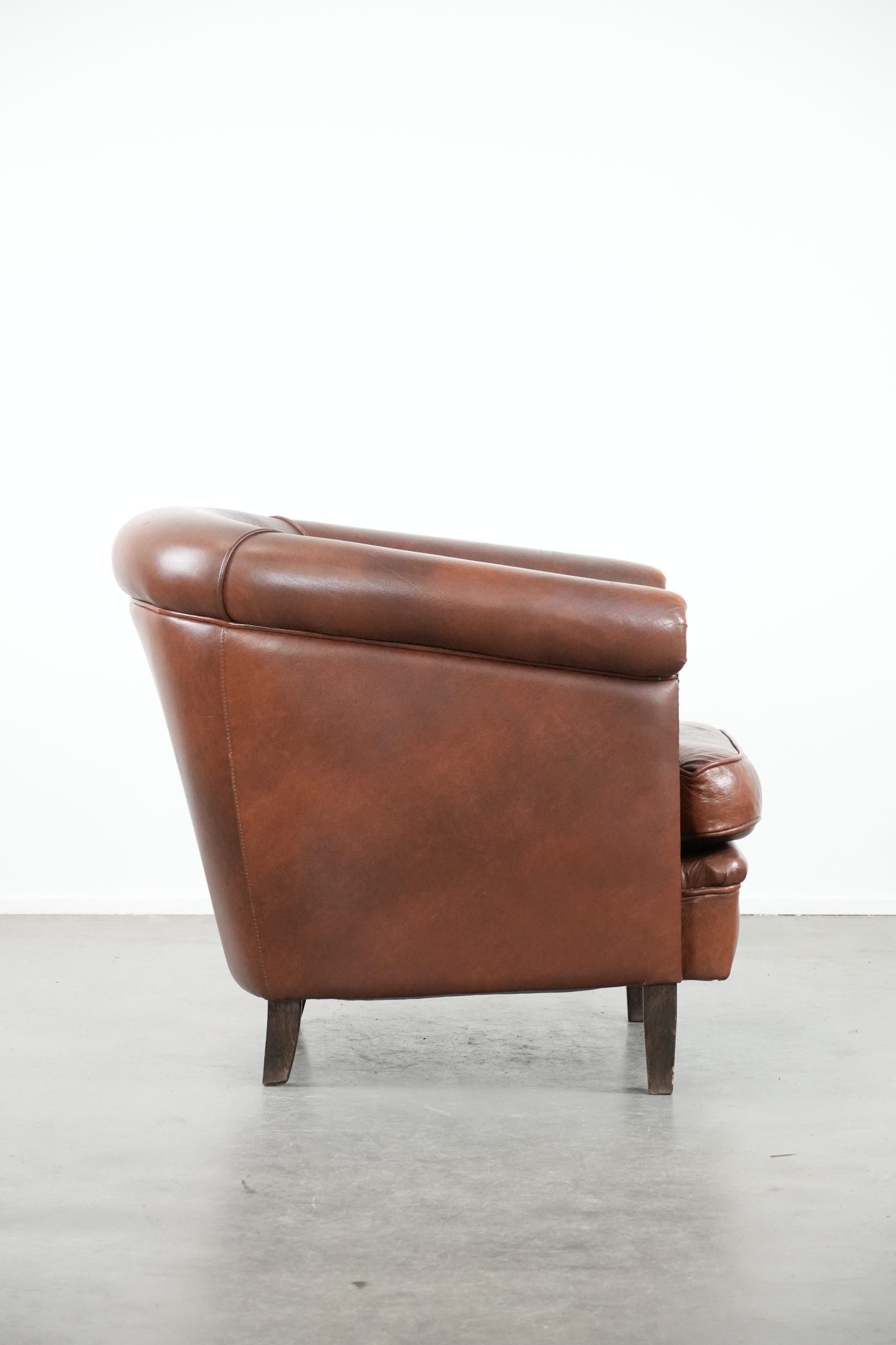 Cognac-coloured cow leather club armchair in English style