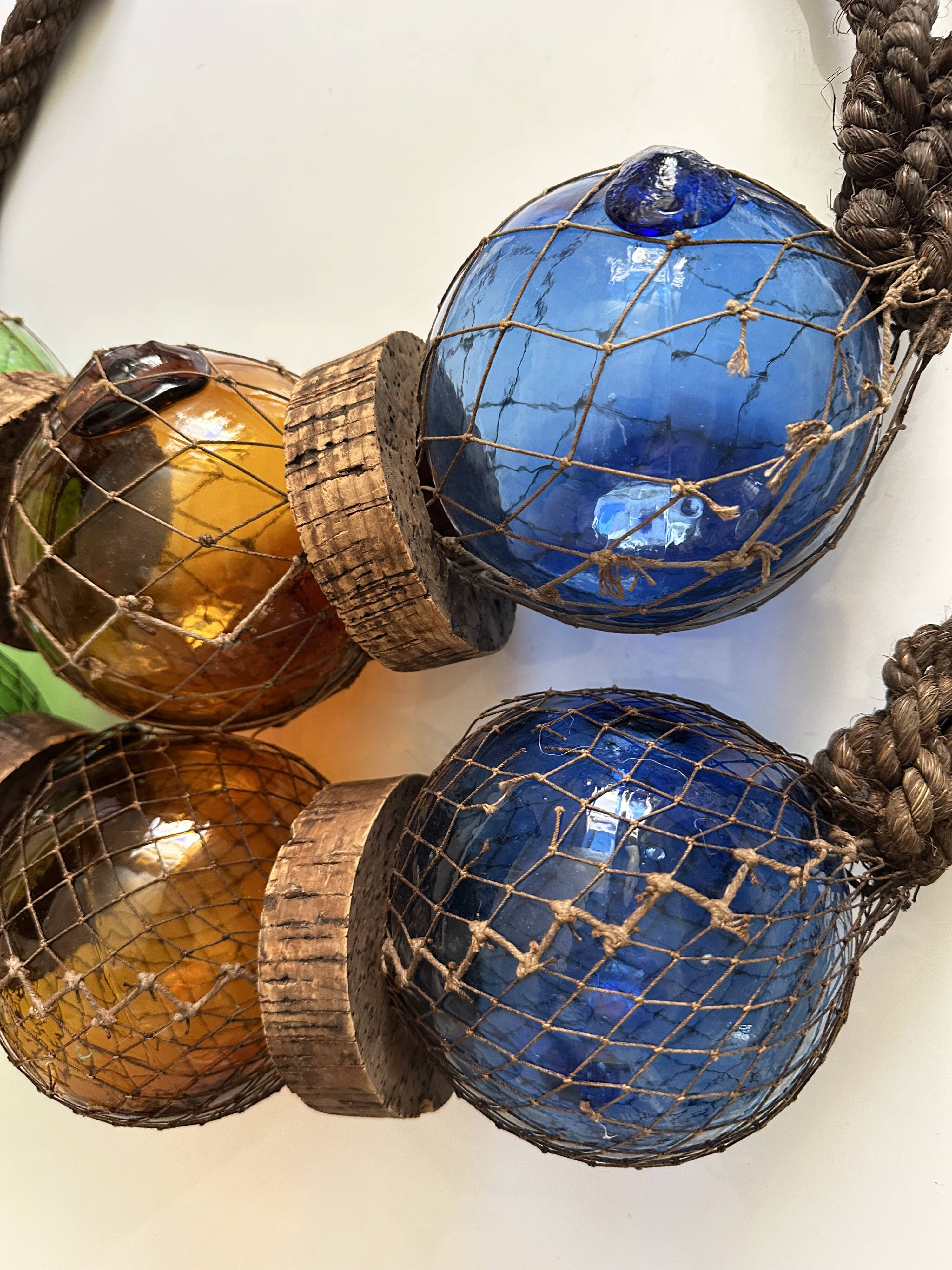 Fishing floats made of blown glass, cork, and rope. France, 1960s.