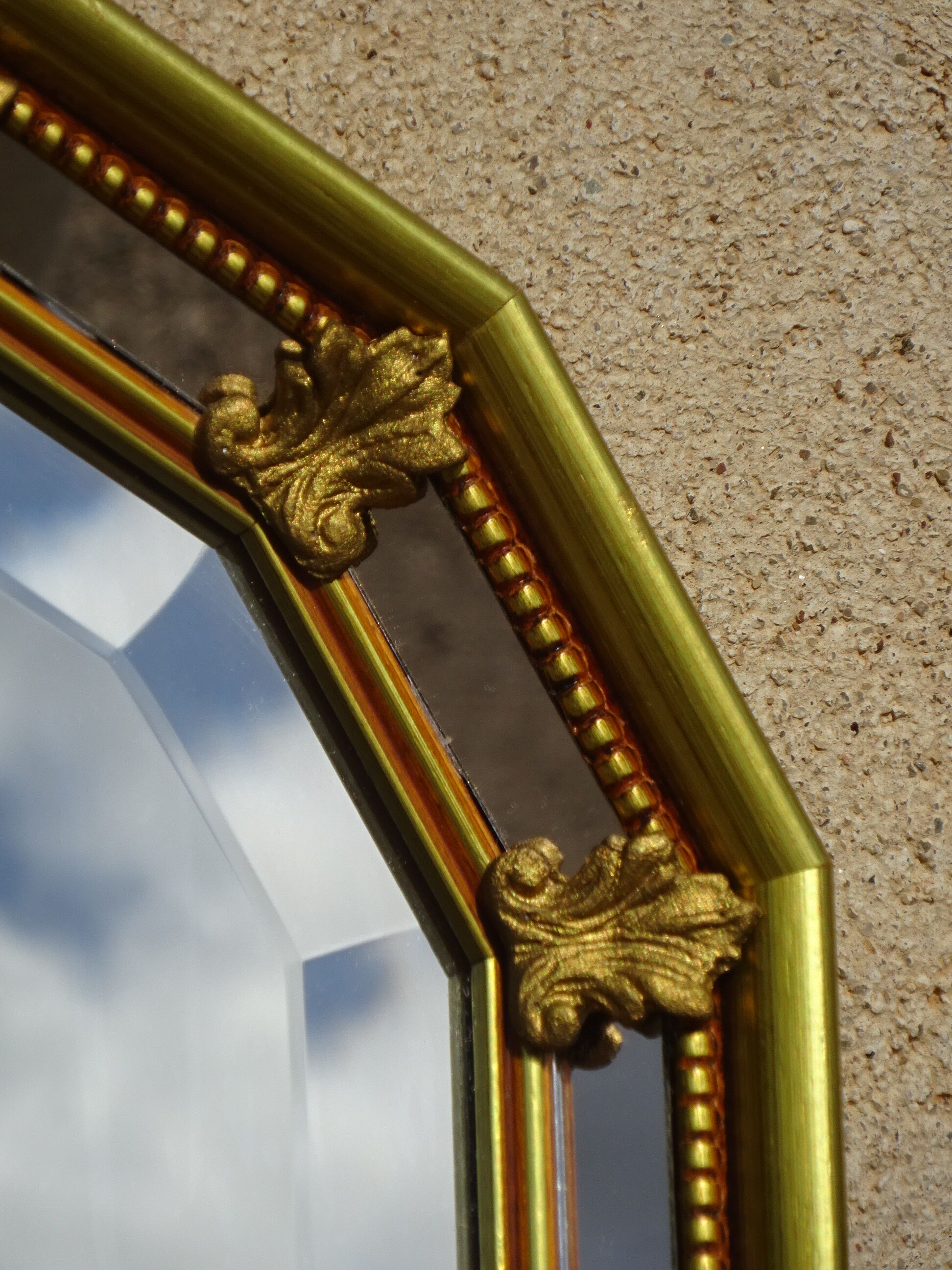 Vertical mirror, gold frame with beading.