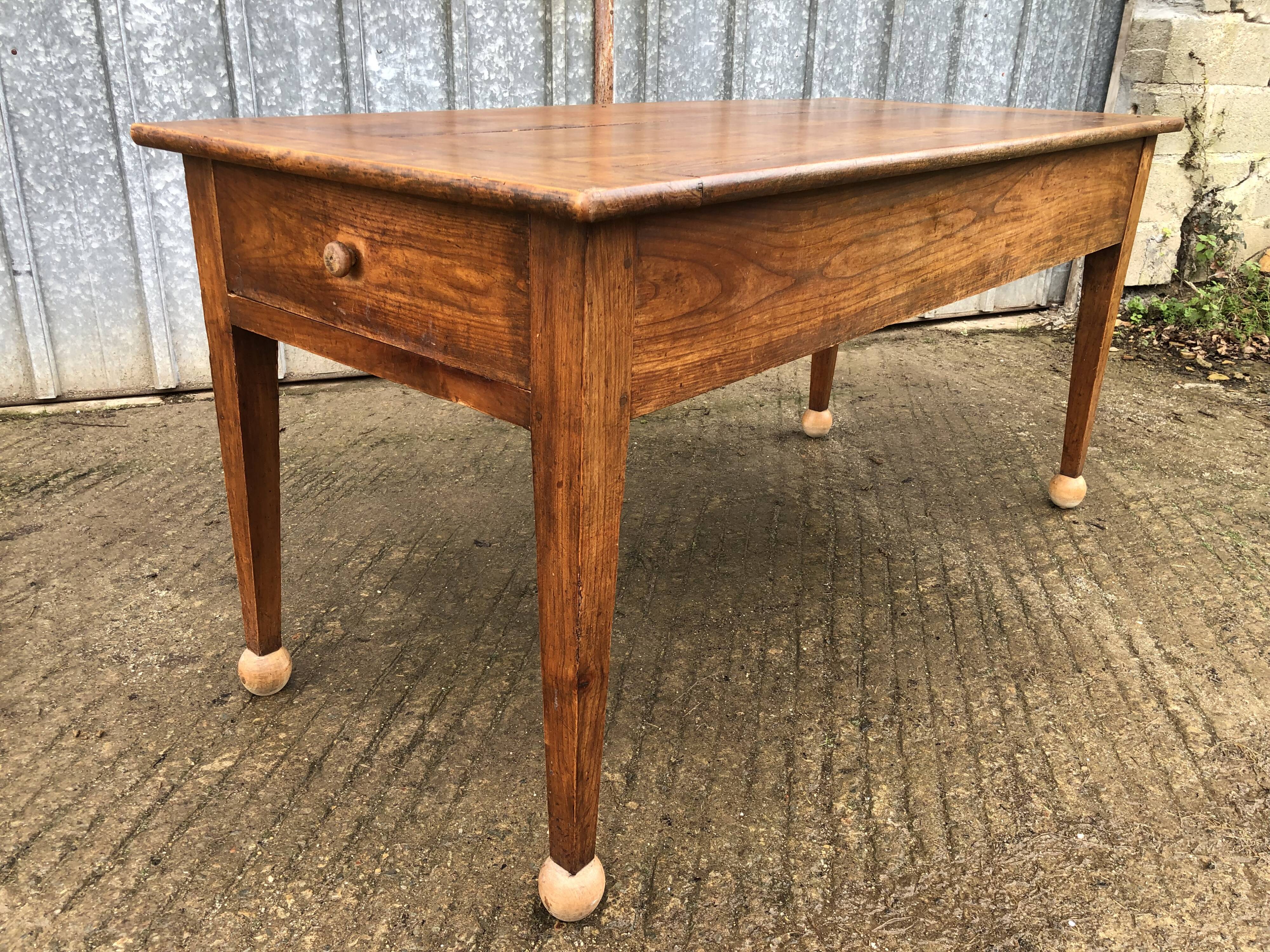 Antique solid cherry farmhouse table with 2 end drawers and 1 pull-out.