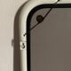 White tubular metal wall mirror