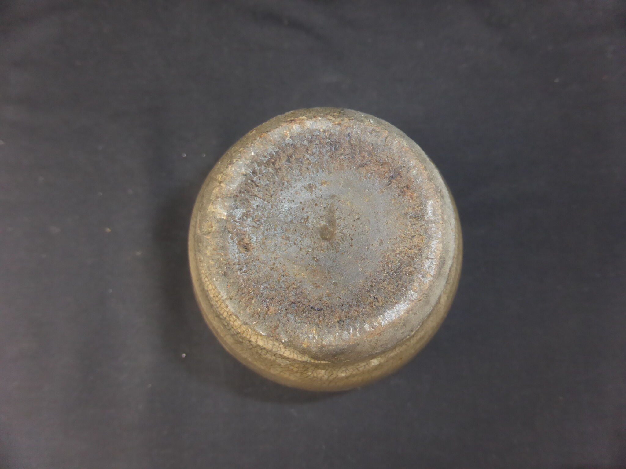 Ancient vase in khaki grey-green cracked sandstone