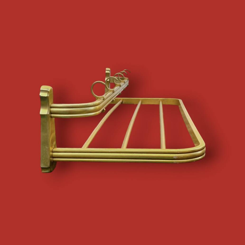 Vintage wall-mounted coat rack in anodised gold aluminium with hat holder.