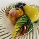 Covered basket in white woven ceramic and fruit slip.