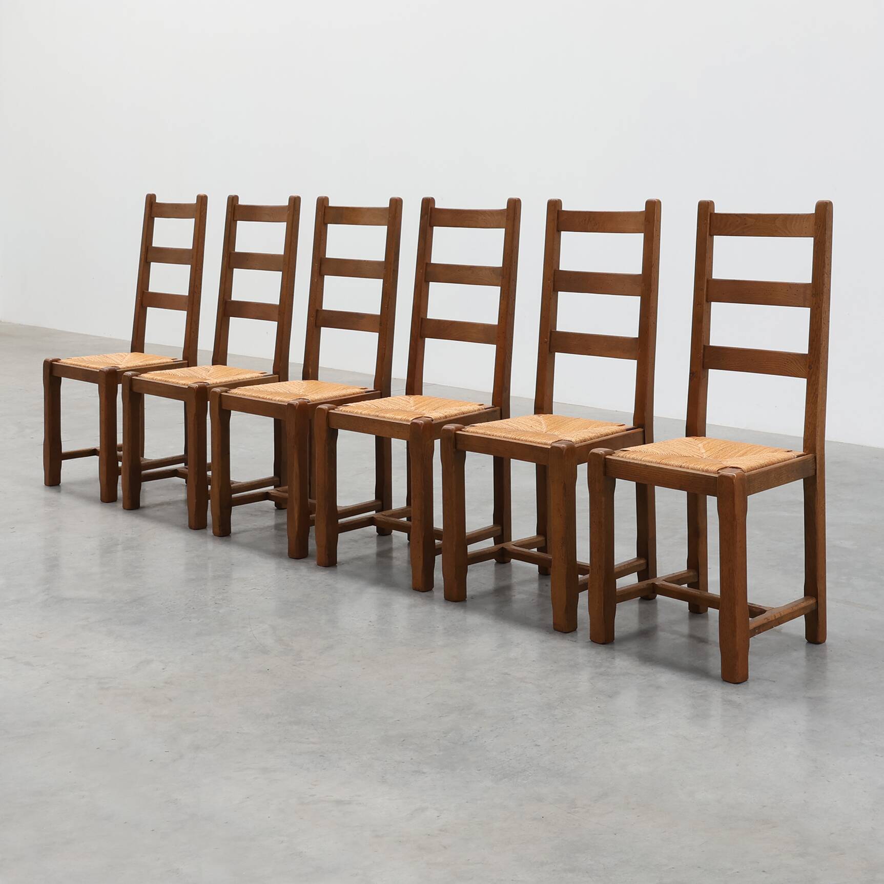 Set of 6 rustic oak ladder-back chairs with rush seats, France, 20th centur