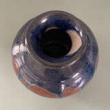 Old blue and brown vase with drips.