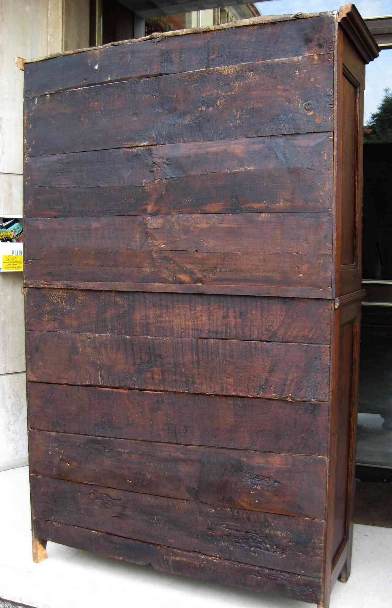 Antique solid wood wardrobe in historical rustic style from the 19th century.
