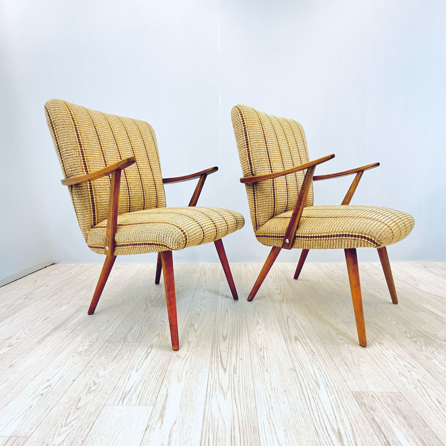 A pair vintage cocktail chairs with stripes and metal screws