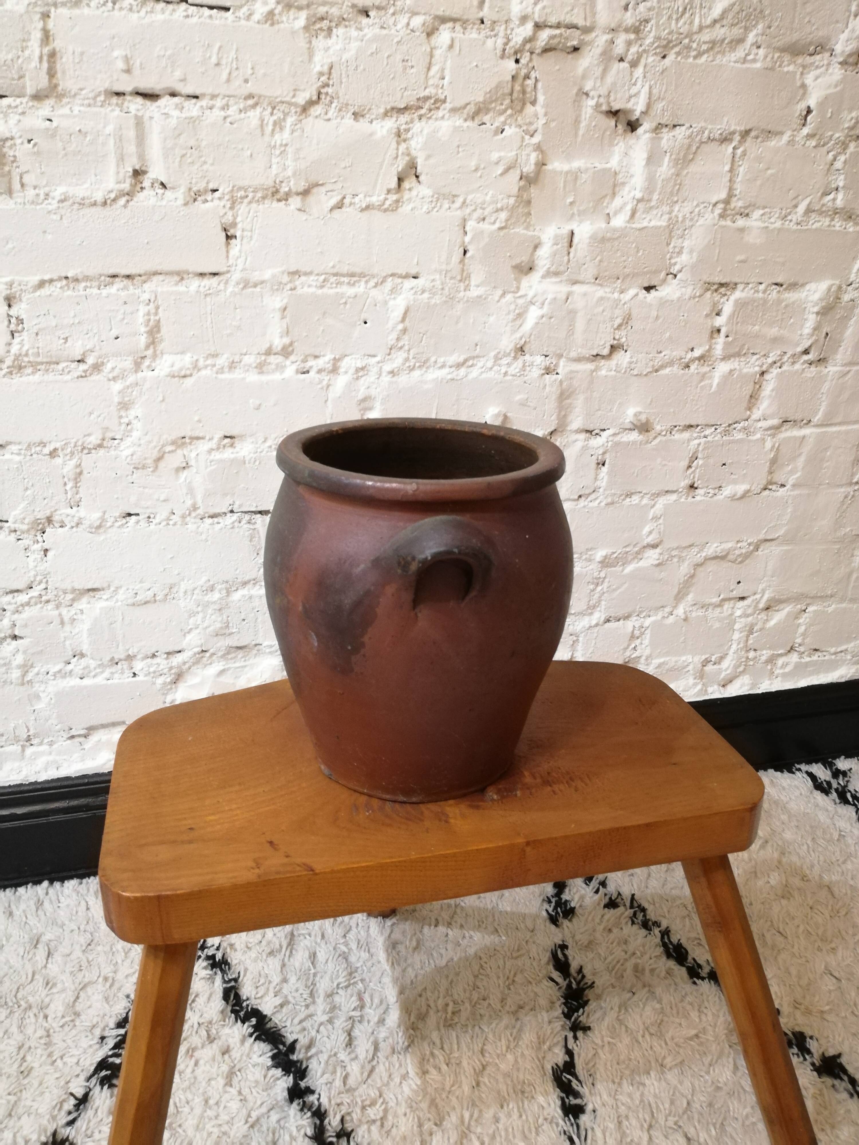 Old red and black terracotta grease pot