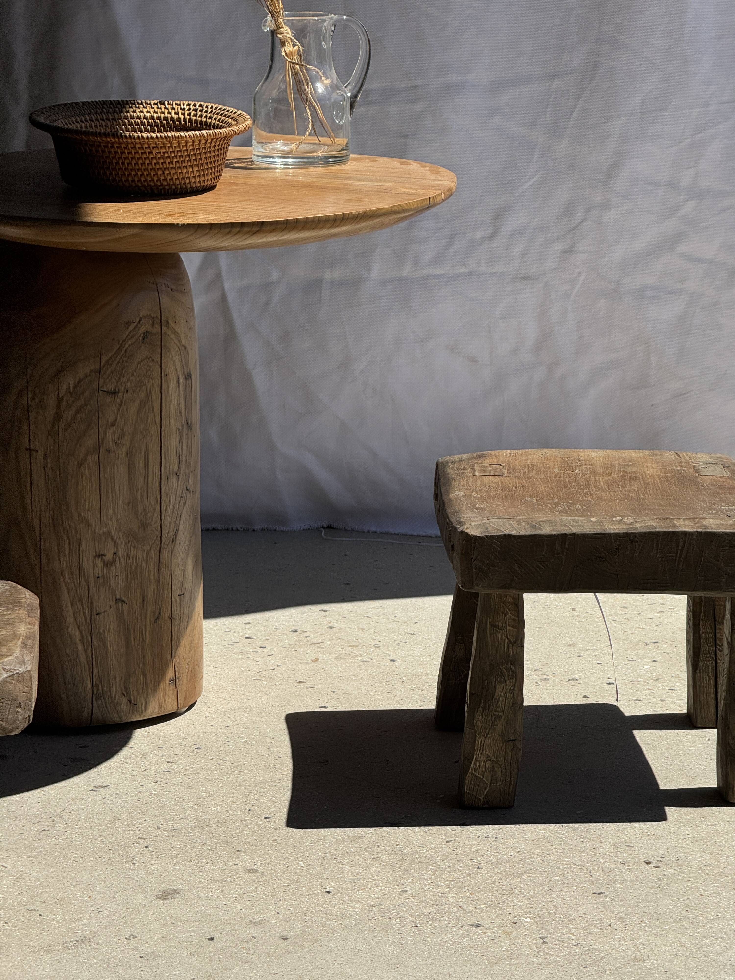 Small stool, square solid teak side table with a curved seat.