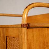 Small storage unit in cane and wood.