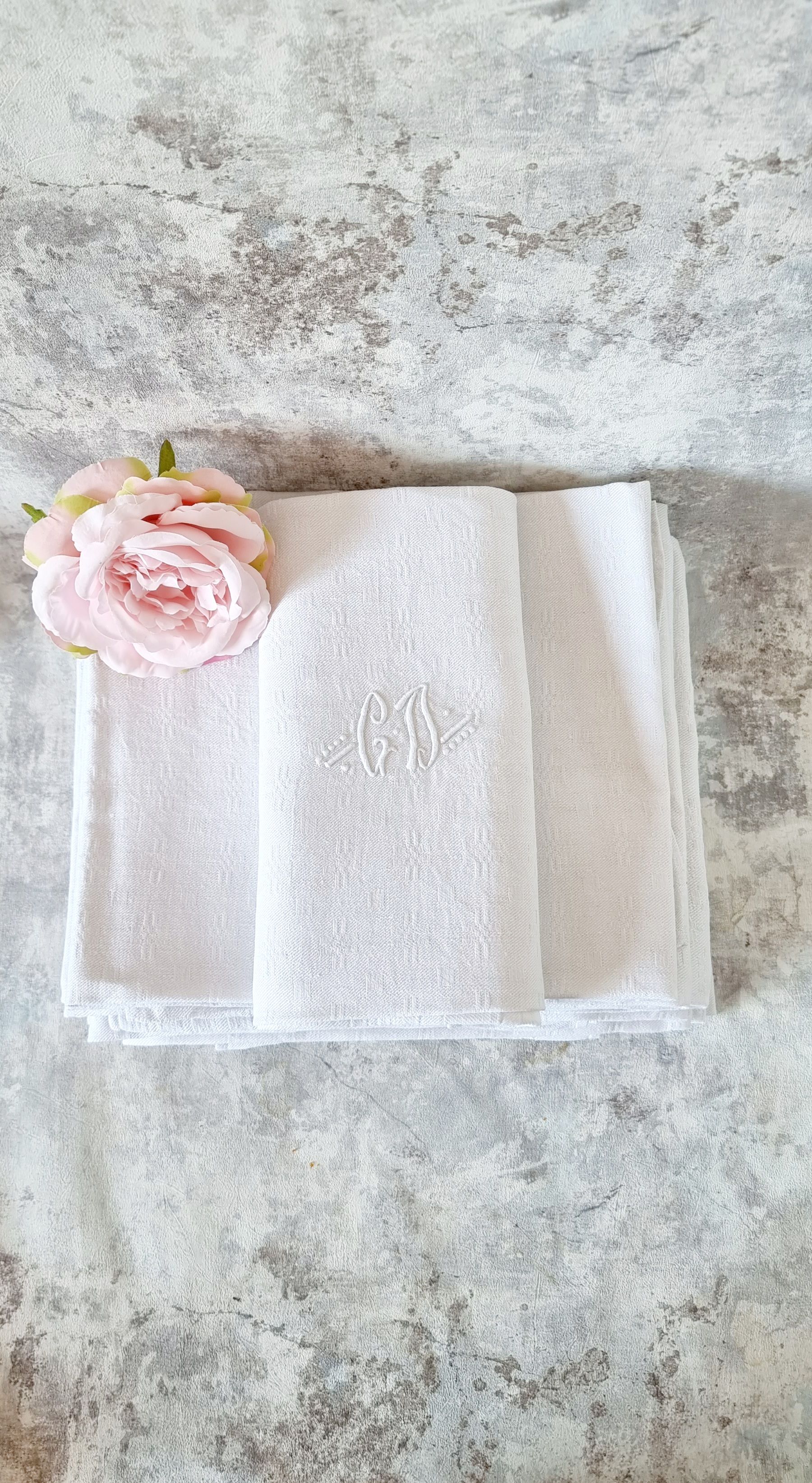 12 antique French linen towels with damask embroidery with "GB" anagrams.
