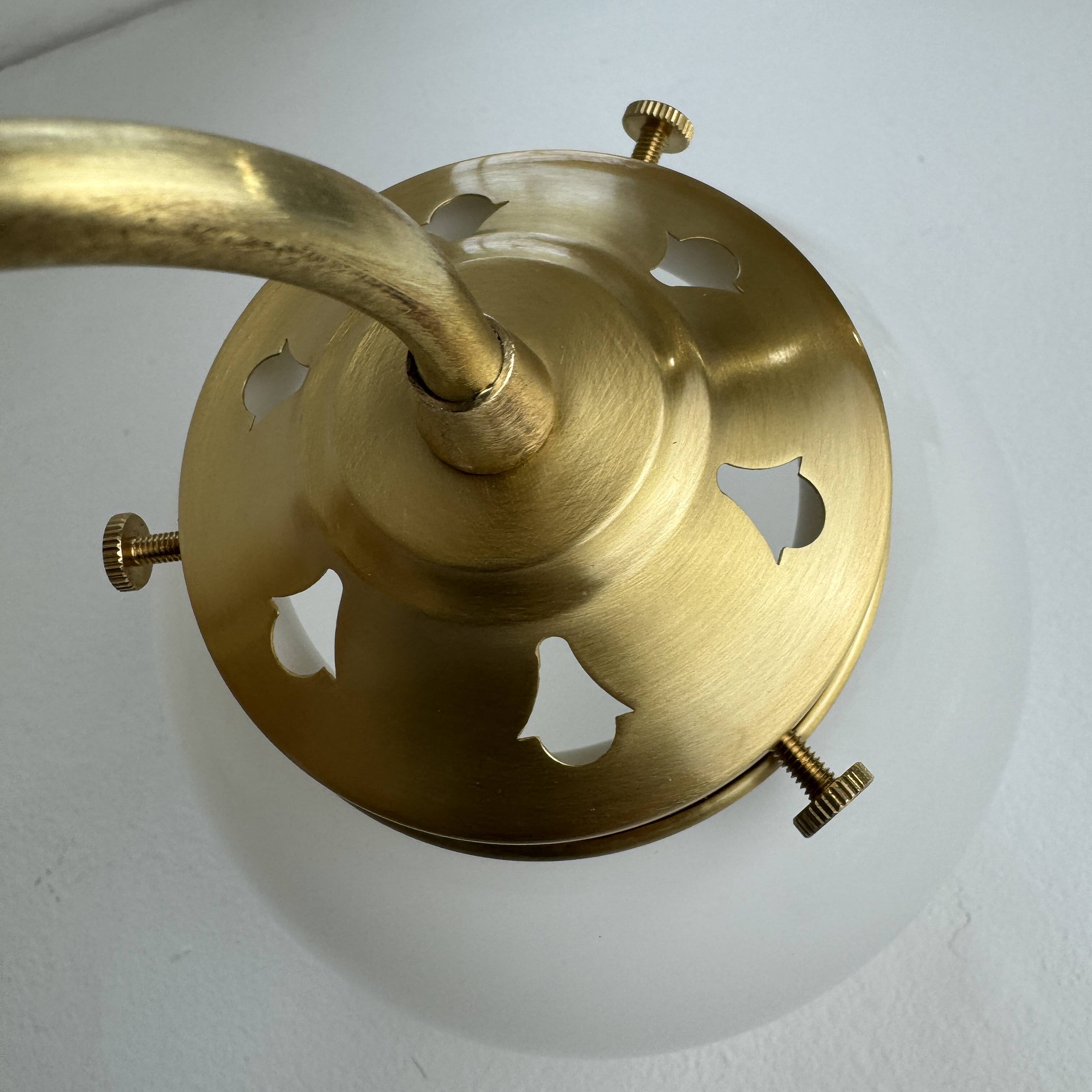 A pair of vintage opaline and brass wall lights