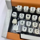 WE typewriter orange
