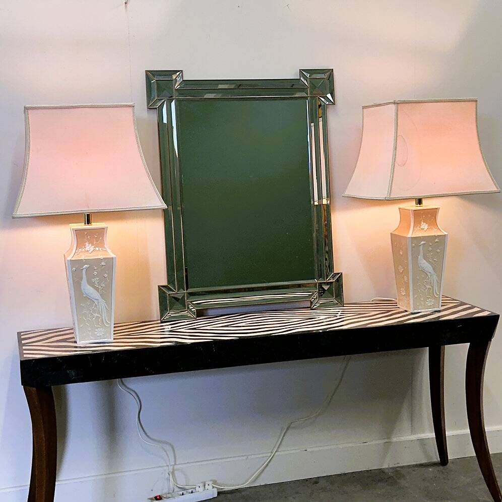 Pair of large cream ceramic table lamps with relief peacocks and fabric shades