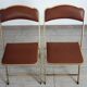 2 golden metal chairs with faux leather in the 60s/70s Opera style.