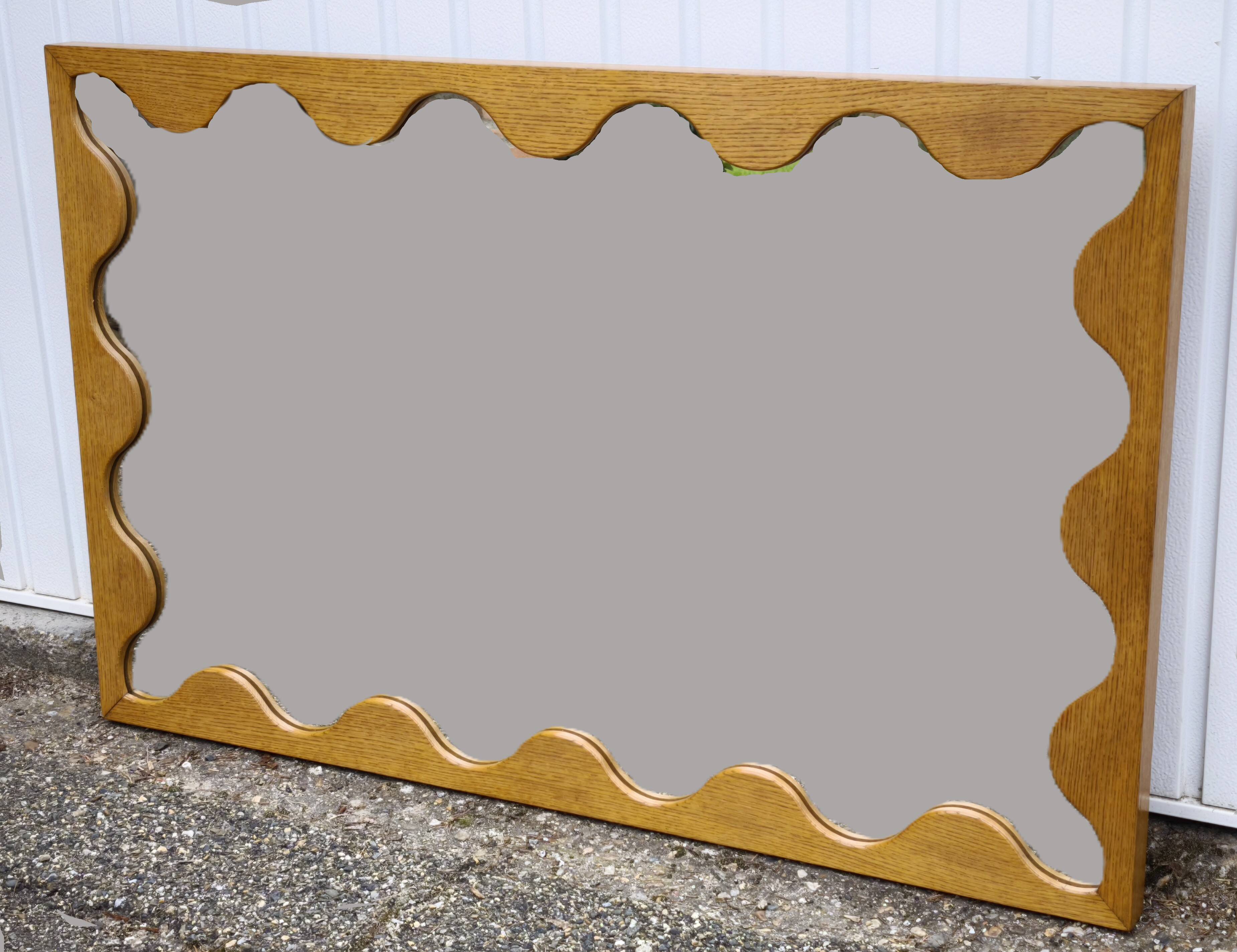 Large antique mirror with an oak frame.