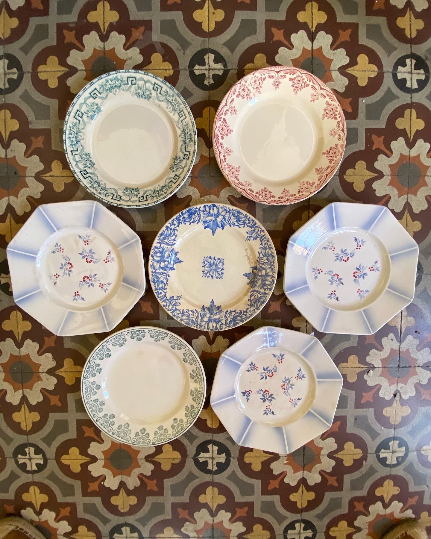 7 matching dessert plates in red green and blue.