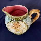 Small onnaing barbotine jug with lion decoration