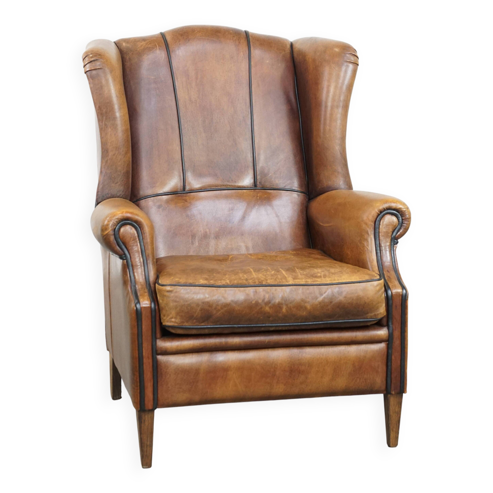 Sheep leather wingback chair finished with black piping