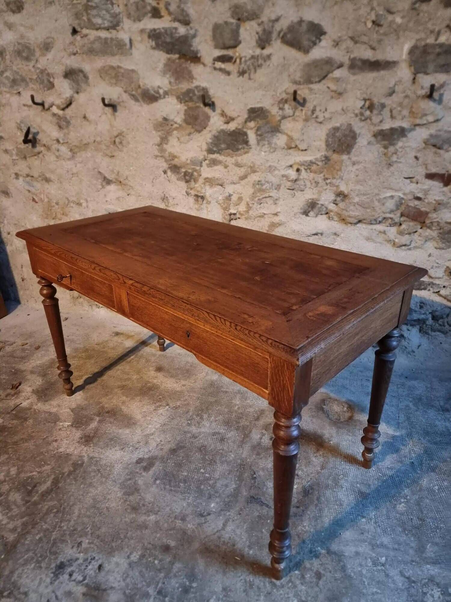 Antique French writing desk in oak with two drawers, 1920s.