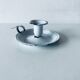 Old candle holder in white enameled metal