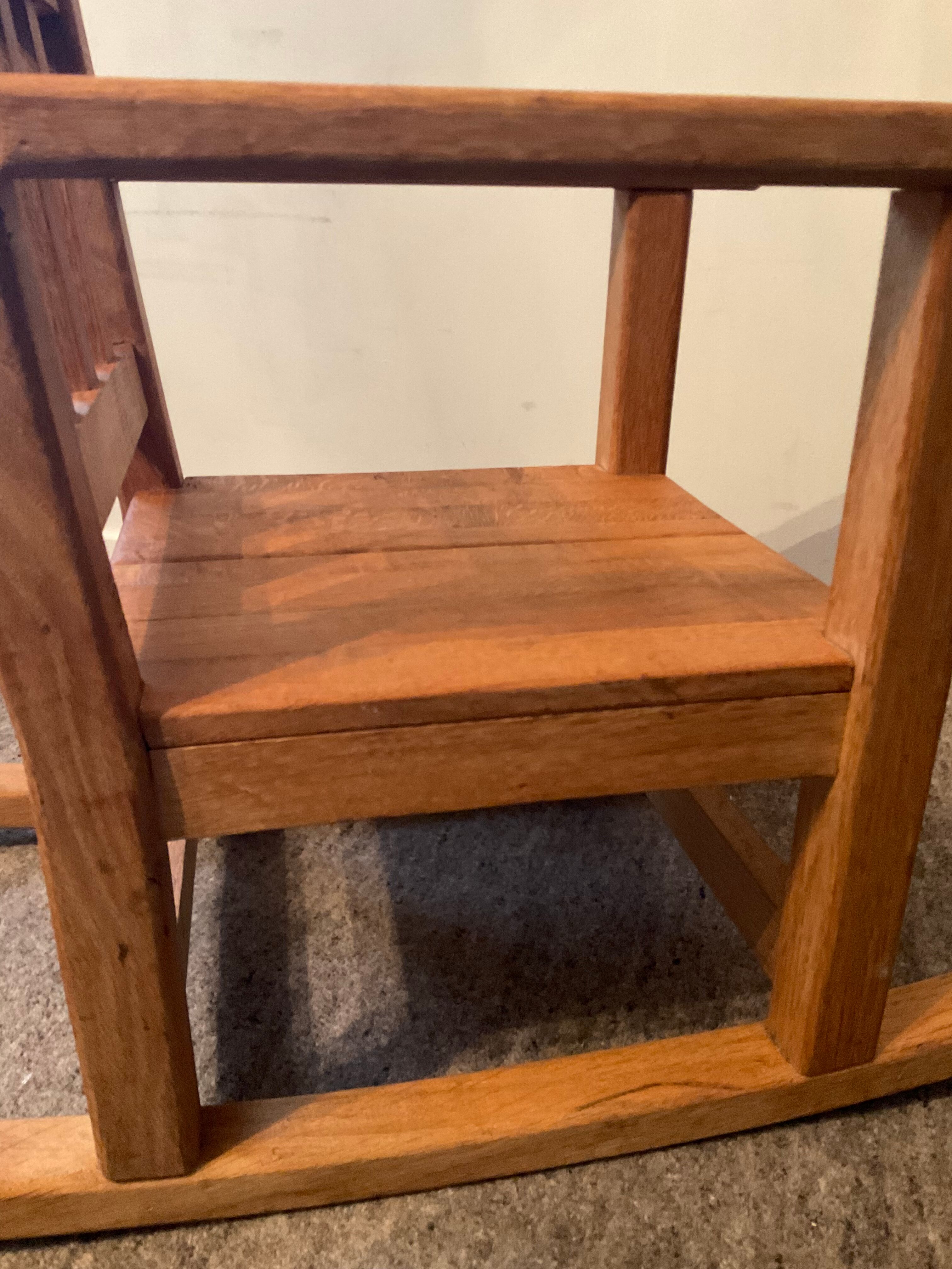 Old children's rocking chair in solid wood